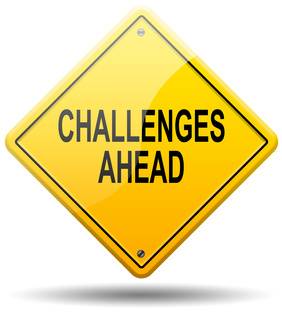 An image of a yellow diamond-shaped warning sign with black text in the center that reads "Challenges Ahead."