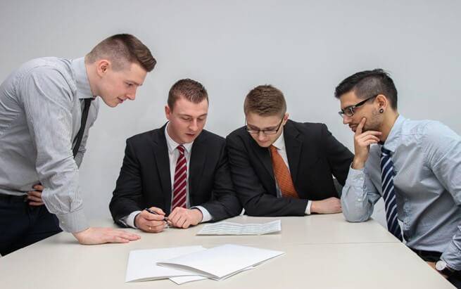 A group of businessmen discussing background checks.