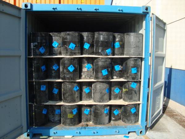 Bulk calcium carbide drums stacked in a shipping container