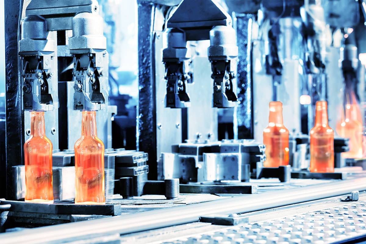 Glass bottles being manufactured in a plant 